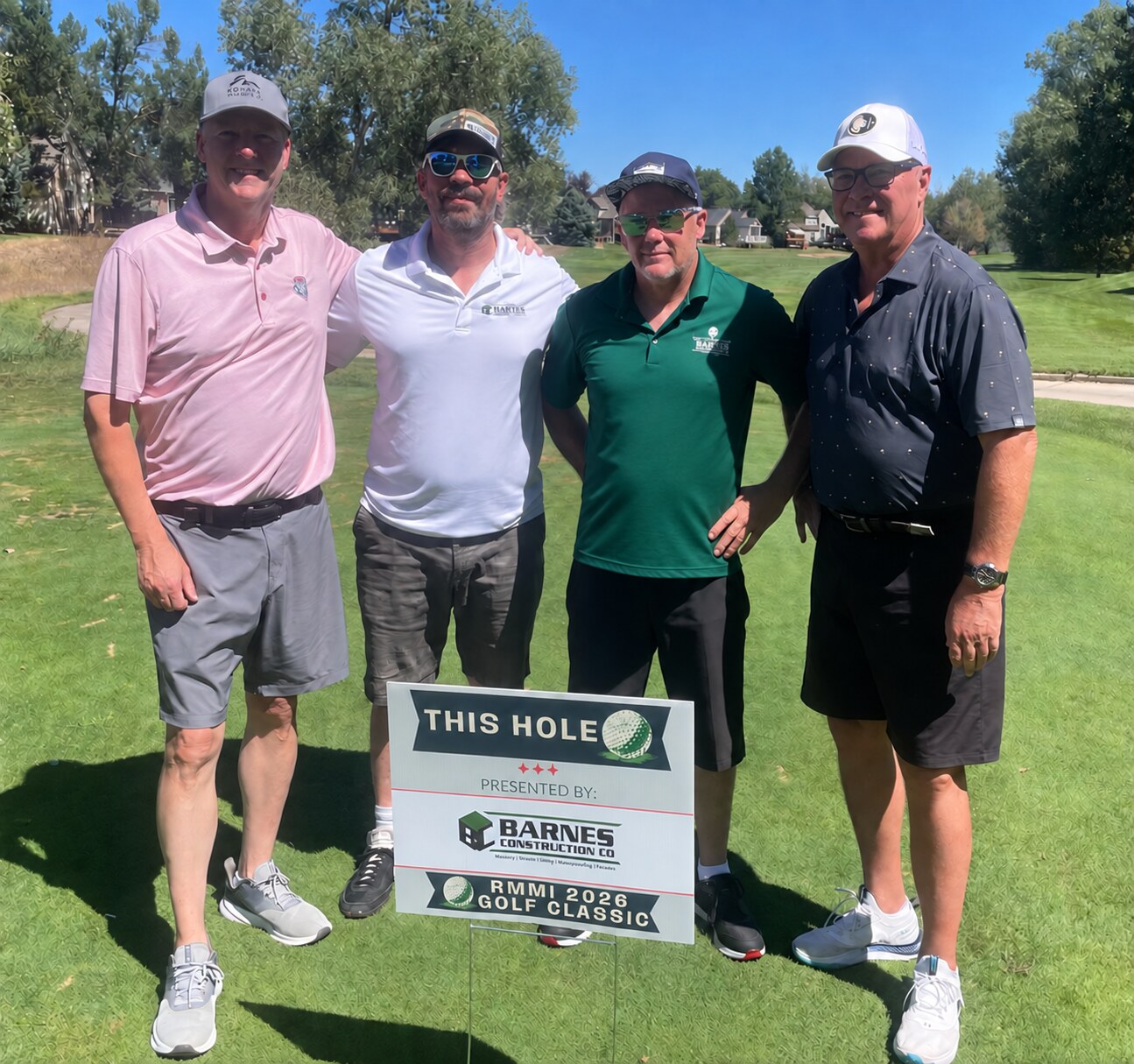 Barnes Construction team at the 2026 RMMI Golf Classic beside the Barnes-presented hole sign